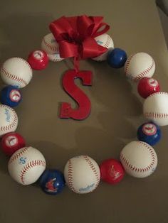 a wreath made out of baseballs and balls with the letter s on it's side