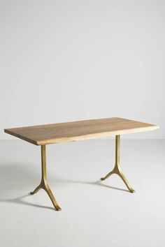 a wooden table sitting on top of a white floor