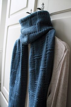 a blue scarf hanging on the side of a door