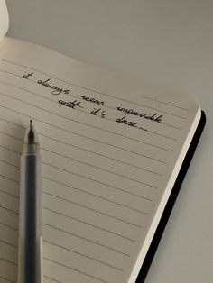 a notepad with writing on it and a pen resting on the page next to it