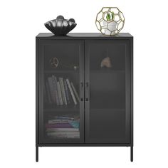 a black cabinet with some books and a vase on top