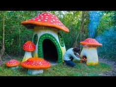 a man kneeling down in front of a mushroom house