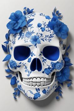 a white skull with blue flowers on it