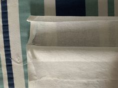 three pieces of white fabric with blue and green stripes