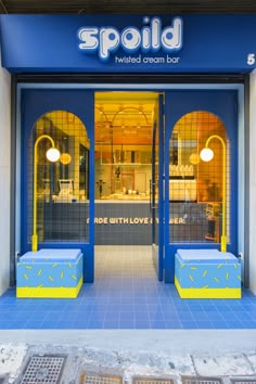 a store front with blue and yellow doors