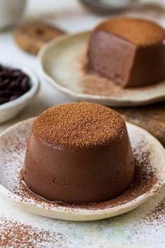 three plates with desserts on them sitting on a table