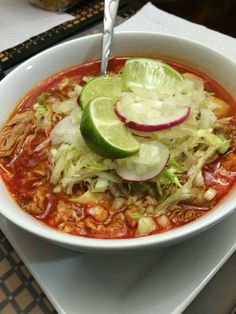 a white bowl filled with soup on top of a table