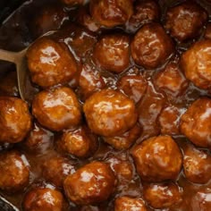 the meatballs are being cooked in the crockpot with sauce on them and ready to be eaten