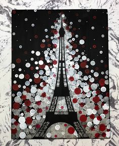 the eiffel tower is surrounded by red and white confetti on black paper