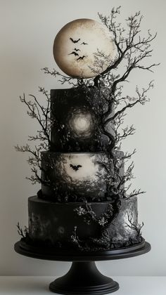 Deep black tiers, shimmering stars, and moon motifs make this gothic cake a standout choice for unique weddings. Check out more gothic cake designs on our website! Amazing Cakes Unique, Goth Wedding Party, Star Wars Tarot, Horror Food, Wedding Cakes Unique