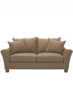 a beige couch with pillows on it