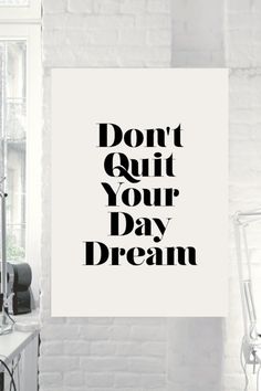 a black and white poster with the words don't quit your day dream on it