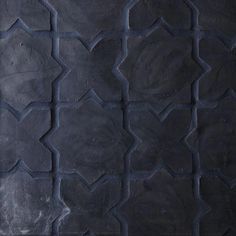 an image of a black tile pattern that looks like it is made out of cement