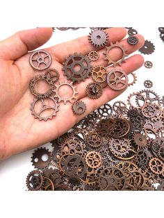 a hand holding several different types of gears