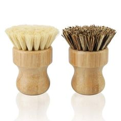 two wooden shaving brushes sitting on top of each other