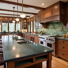 a large kitchen with an island in the middle and lots of cabinets on both sides