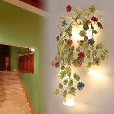 there is a light that has flowers on it and the stairs are made out of wood