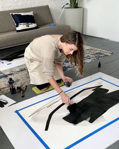 a woman is working on an art piece