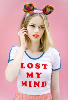 a woman with long blonde hair wearing a t - shirt that says lost my mind