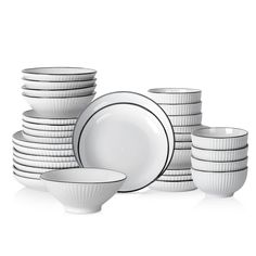 a stack of white plates and bowls with black rims