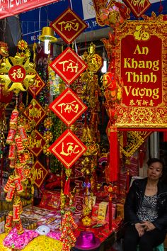 a woman standing in front of a store selling decorations