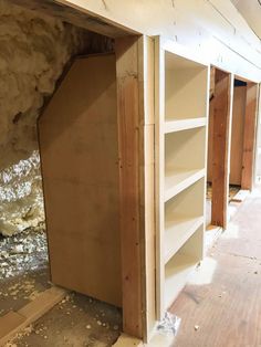 an unfinished room with some shelves in it