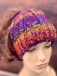 a mannequin head wearing a multicolored knitted hat