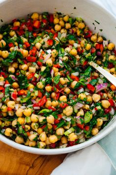 a white bowl filled with chickpeas and vegetables