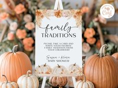 a sign that is sitting on top of a table with pumpkins and flowers in the background