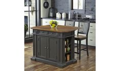 a kitchen island in the middle of a wooden floor