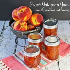 peach jalapeno jam in jars on a towel next to a bowl of peaches