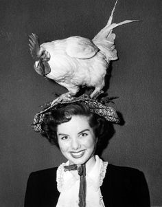 a woman wearing a bird on top of her head