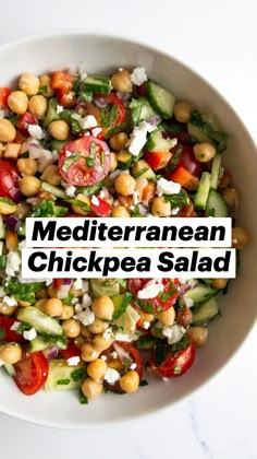 a white bowl filled with lots of different types of food on top of a table