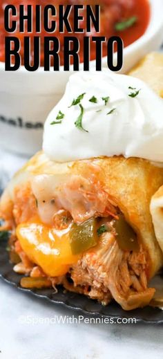 chicken burrito with sour cream on top