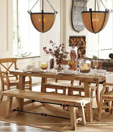 a dining room table with chairs and a bench in front of it, next to a couch