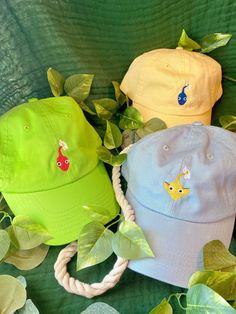 FAST SHIPPING! We guarantee your order will ship within 5 days! **Delivery time is dependent on region and local Postal Services.** Inspired by the game these cuties are named for. These caps are customizable, choose the color of your cap with your choice of Pikmin! Hat is unisex sized, cotton, and features an adjustable strap. Hat size: 6 5/8 - 7 3/8 **If you have any questions on choosing the hat and pikmin combo you want, please send us a message. We are always happy to help Pikmin Embroidery, Cute Cotton Baseball Cap, Cute Cotton Baseball Cap With Curved Brim, Cute Cotton Curved Brim Baseball Cap, Cute Cotton Trucker Cap, Cute Cotton Trucker Hat, Cute Cotton Snapback Hat, Casual Snapback Hats For Playtime, Adjustable Curved Brim Fun Dad Hat