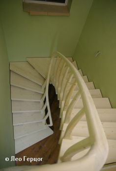 a spiral staircase in a house with green walls