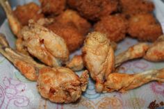 chicken wings and other food items on a paper plate