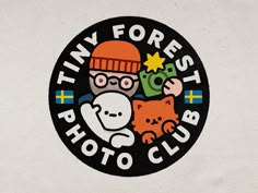 the logo for tiny forest photo club is shown in black, white and orange colors