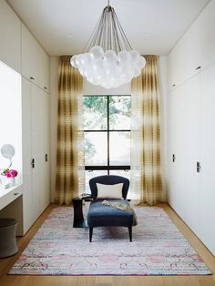 a living room with a couch, chair and large window