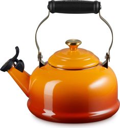 an orange tea kettle with a black handle