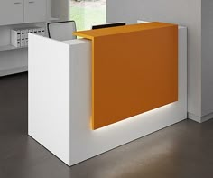 an orange and white reception desk in the middle of a room