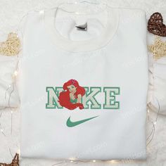 Ariel Flower x Nike Embroidered Shirt Experience the enchantment of Disney with our Ariel Flower x Nike Embroidered Shirt. Made Princess Hoodie, Best Family Gifts, Staying Active, Nike Shirt, Elegant Embroidery, Delicate Flowers, Special Girl, Unique Shirt, Girls Gift