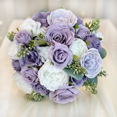 a bridal bouquet with purple and white flowers