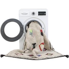 a white washer sitting next to a black and white towel on top of it