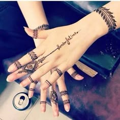 two hands with henna tattoos on them