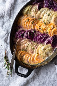 a skillet filled with potatoes and red cabbage