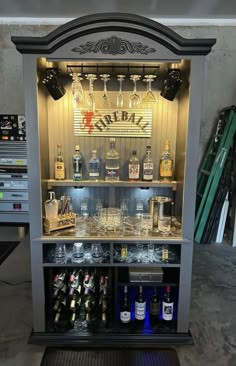 an old fashioned liquor cabinet filled with bottles and glasses