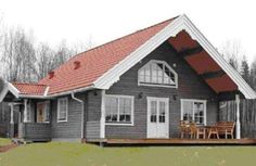 the house is made of wood and has red tile on it's shingles