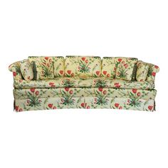 an old fashioned couch with floral fabric on the back and arms, sitting against a white background